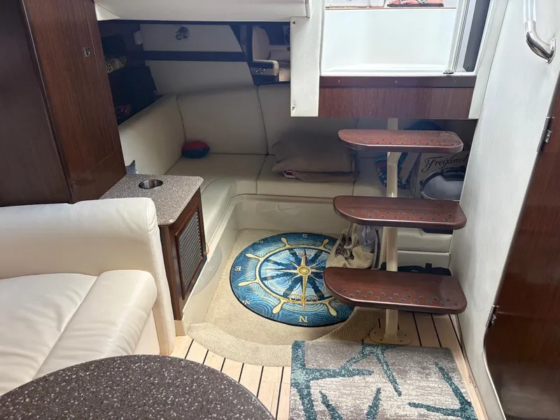 Slide: The Image of Interior of 2013 Cruisers Yachts 350 Express with cozy seating and nautical decor. - 5