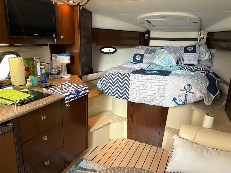 Slide: The Image of Interior of 2013 Cruisers Yachts 350 Express with cozy bed and kitchenette. - 7