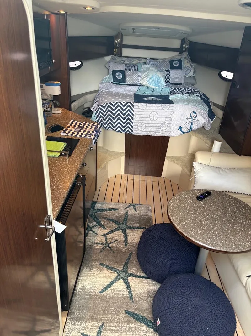 Slide: The Image of Interior of 2013 Cruisers Yachts 350 Express with cozy bed and seating area. - 9