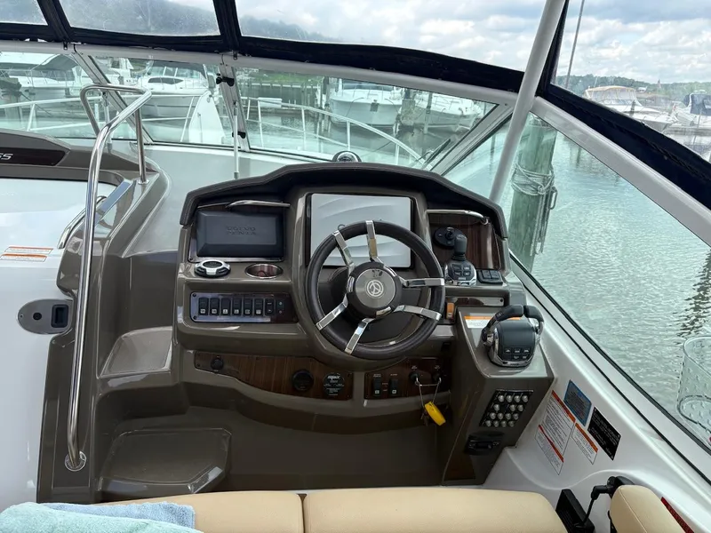 Slide: The Image of Helm of 2013 Cruisers Yachts 350 Express with steering wheel and control panel. - 15