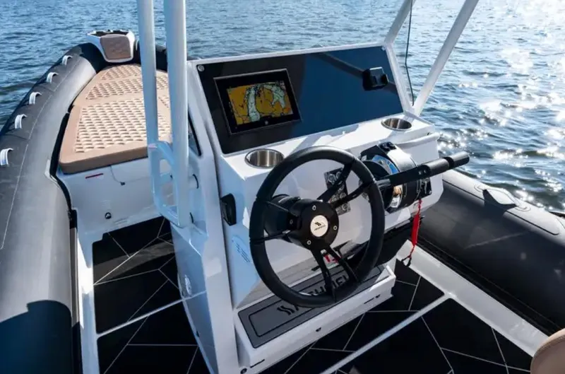 Slide: The Image of 2024 Highfield Sport 800 boat interior with steering wheel and navigation system. - 3