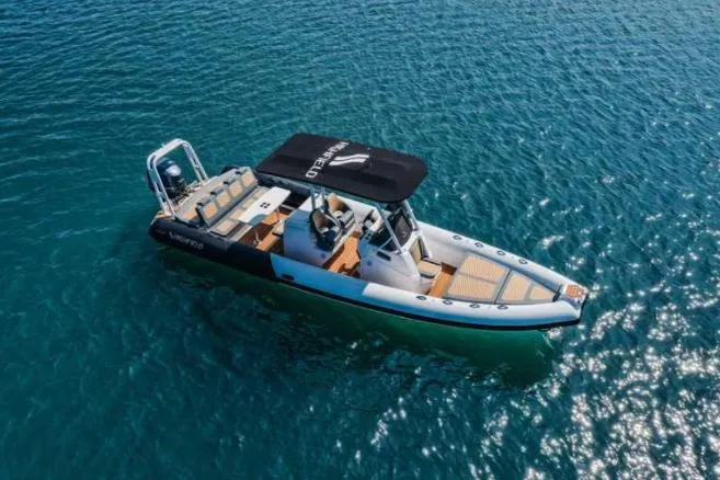 The Image of 2024 Highfield Sport 900 boat cruising on clear blue water. - 0