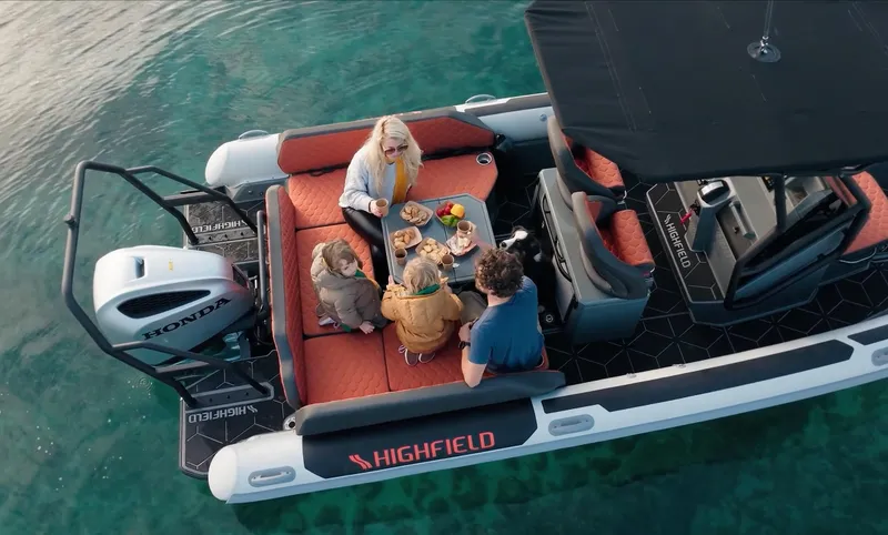 Slide: The Image of 2025 Highfield ADV7 boat with people enjoying a meal on the water. - 3
