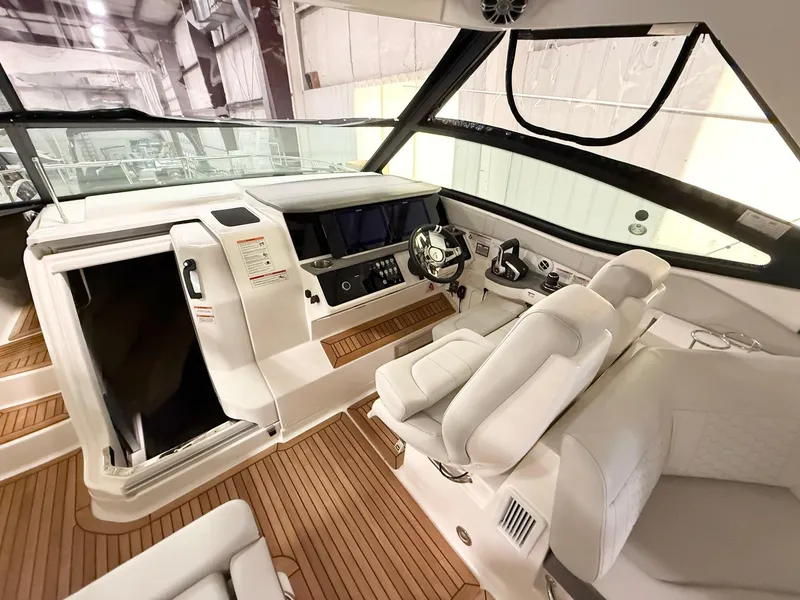 Slide: The Image of 2025 Sea Ray Sundancer 320 cockpit with modern helm and luxurious seating. - 8