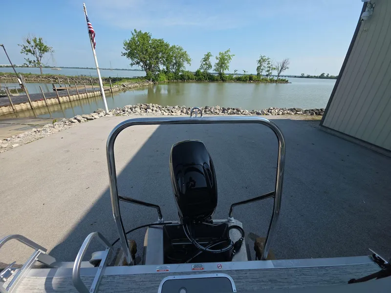 Slide: The Image of 2025 Bennington 20 SL boat at dockside with scenic lake view. - 11