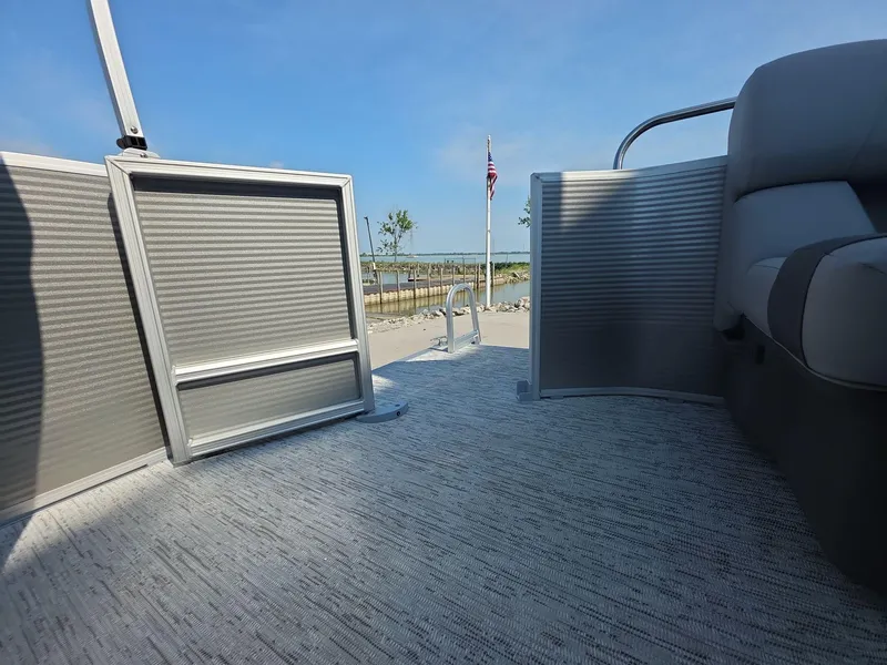 Slide: The Image of 2025 Bennington 20 SL pontoon boat interior with open gate, dockside view. - 12