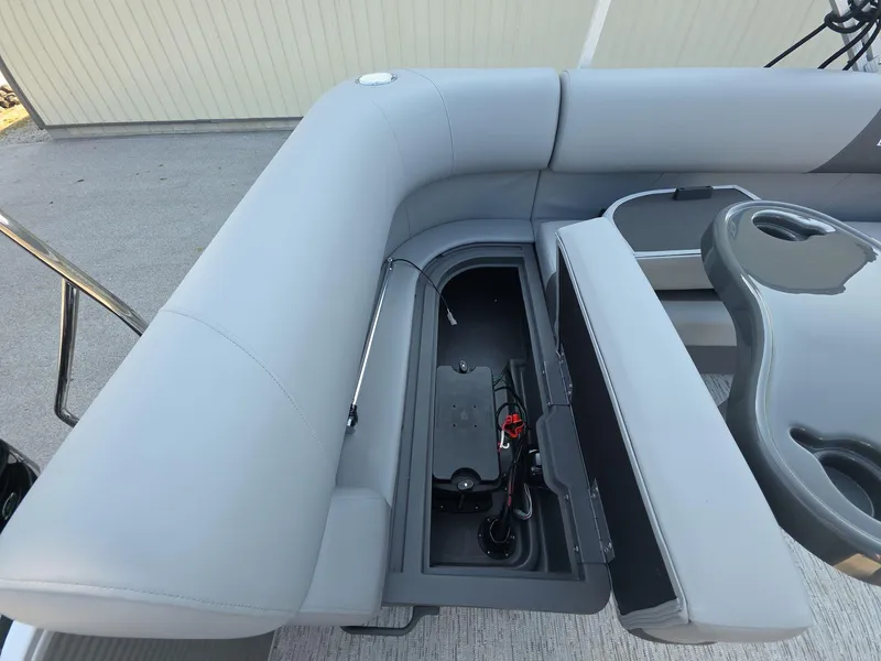 Slide: The Image of Bennington 20 SL 2025 boat interior with open storage compartment and seating. - 14