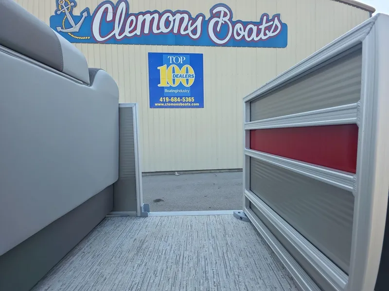 Slide: The Image of 2025 Bennington 20 SL boat at Clemons Boats dealership entrance. - 17