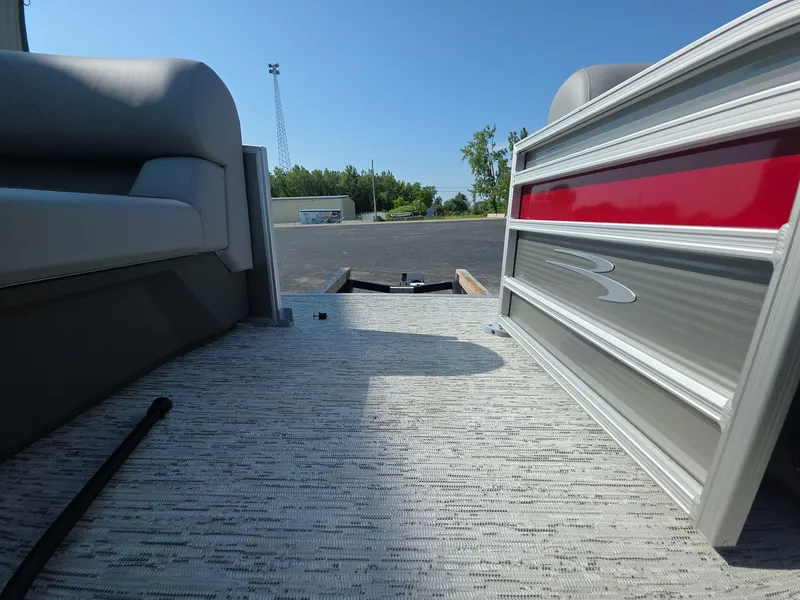 Slide: The Image of 2025 Bennington 20 SL pontoon interior with red accent, outdoor setting. - 18