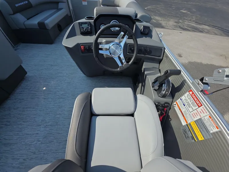 Slide: The Image of 2025 Bennington 20 SL boat cockpit with steering wheel and control panel. - 6