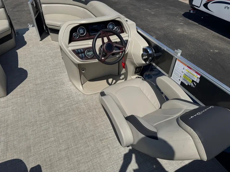 Slide: The Image of 2023 South Bay 224RS LE 2.75 Tritoon interior with steering console and seating. - 13