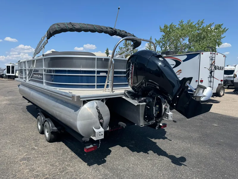 Slide: The Image of 2023 South Bay 224RS LE 2.75 Tritoon on trailer, featuring Mercury outboard motor. - 4