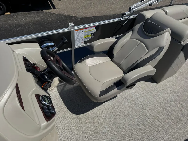 Slide: The Image of Captain's chair and helm of 2023 South Bay 224RS LE 2.75 Tritoon boat. - 7