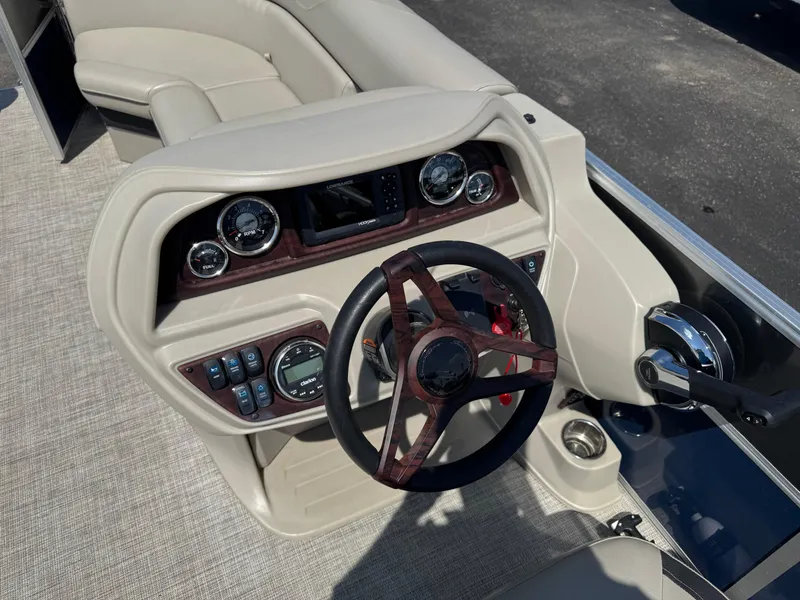 Slide: The Image of 2023 South Bay 224RS LE 2.75 Tritoon dashboard with steering wheel and controls. - 8
