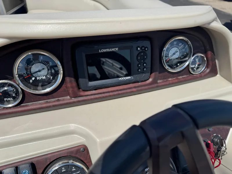 Slide: The Image of Dashboard of 2023 South Bay 224RS LE 2.75 Tritoon with gauges and Lowrance display. - 9