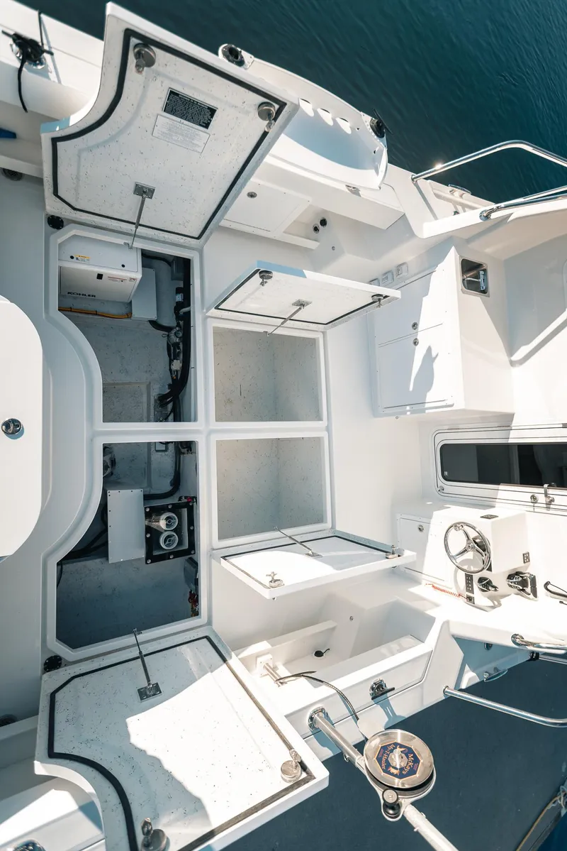 Slide: The Image of 2025 Lindell 38' boat interior with open storage compartments and steering wheel, viewed from above. - 10