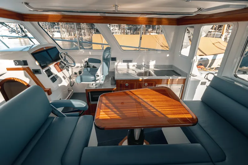 Slide: The Image of Interior of 2025 Lindell 38' yacht with helm, seating, and kitchenette. - 3