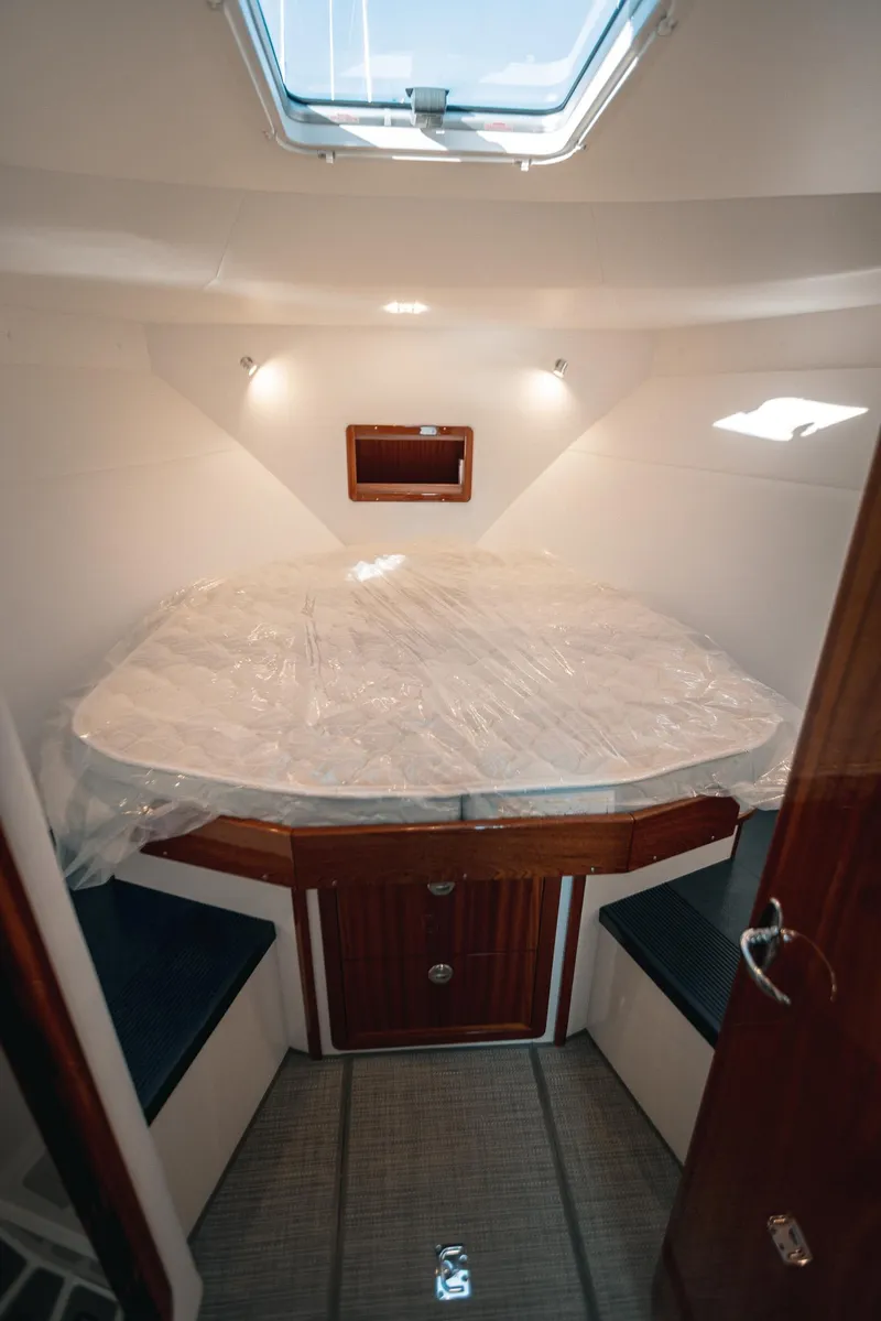Slide: The Image of Cozy cabin interior of 2025 Lindell 38' boat with skylight and wooden accents. - 5