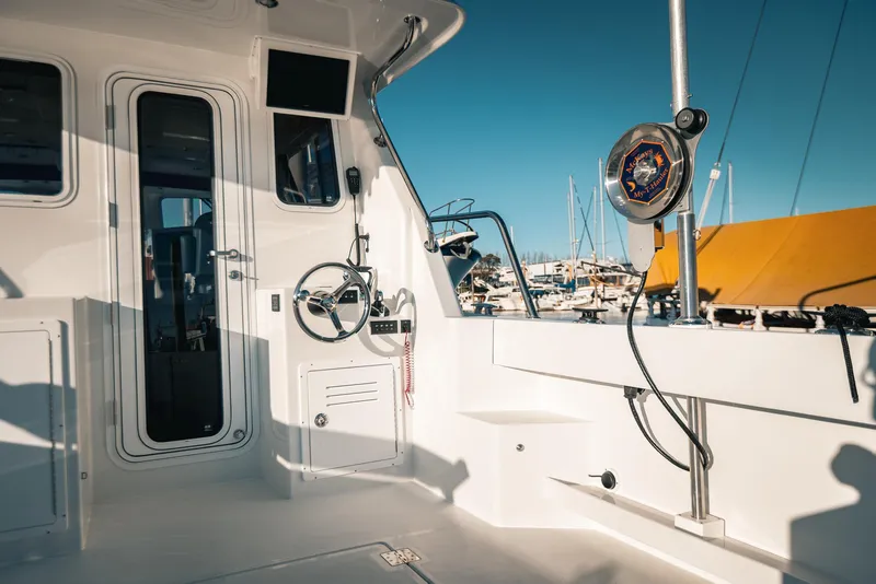 Slide: The Image of Interior view of a 2025 Lindell 38' boat, featuring a steering wheel and control panel. - 9