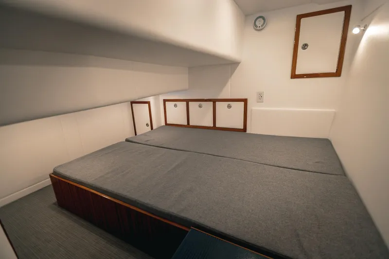 Slide: The Image of Cozy cabin interior of 2027 Lindell 38' boat with comfortable bedding and storage. - 12