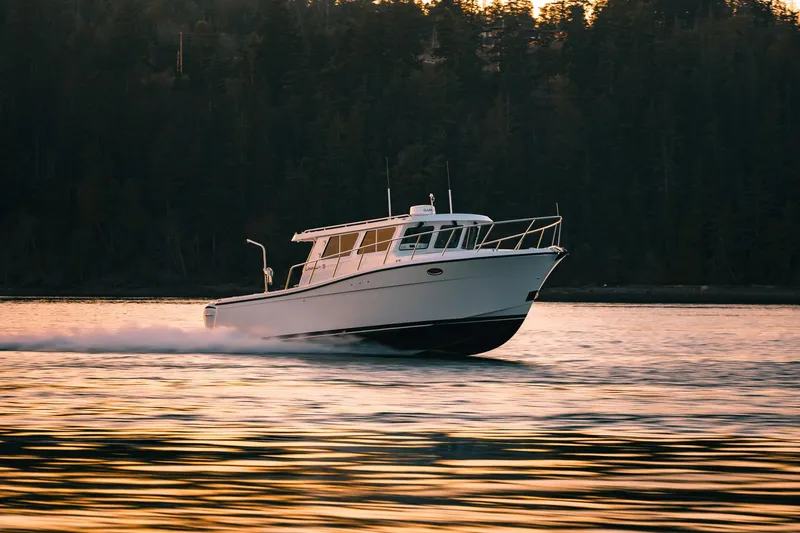 Slide: The Image of 2027 Lindell 38' boat cruising on calm water at sunset. - 19