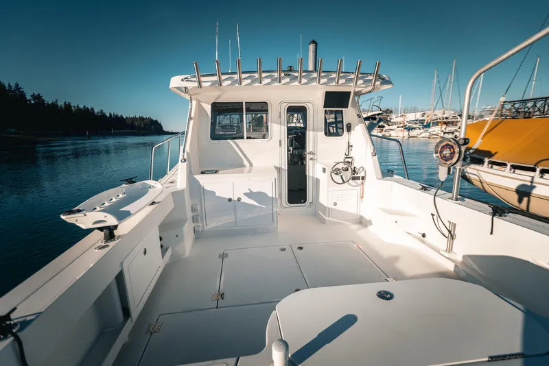 Slide: The Image of 2025 Lindell 38' boat interior with open storage compartments and steering wheel, viewed from above. - 6