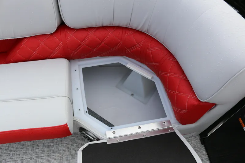 Slide: The Image of Red and white seating on 2025 SunCatcher Elite 324 RC boat, featuring storage compartment. - 13