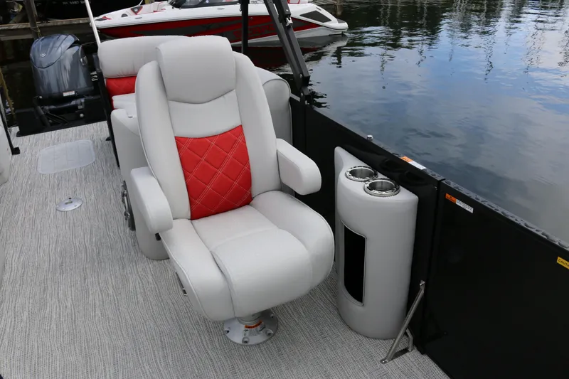 Slide: The Image of Luxurious seating on 2025 SunCatcher Elite 324 RC boat, featuring red accents and cup holders. - 15