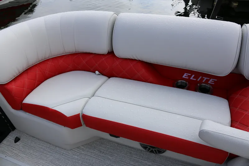 Slide: The Image of Luxurious seating on 2025 SunCatcher Elite 324 RC boat, featuring red and white upholstery. - 26