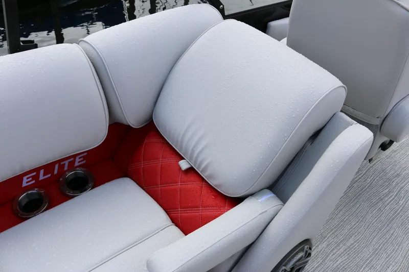 Slide: The Image of Luxurious seating on 2025 SunCatcher Elite 324 RC boat, featuring red and gray upholstery. - 27