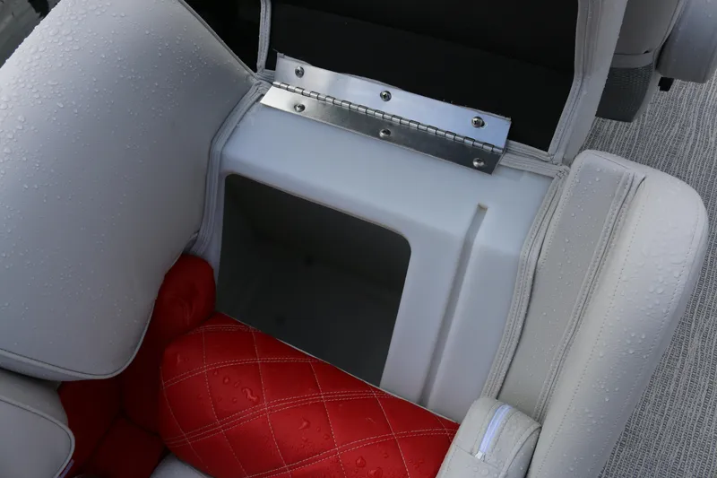 Slide: The Image of SunCatcher Elite 324 RC 2025 boat seat storage with red cushion and water droplets. - 28