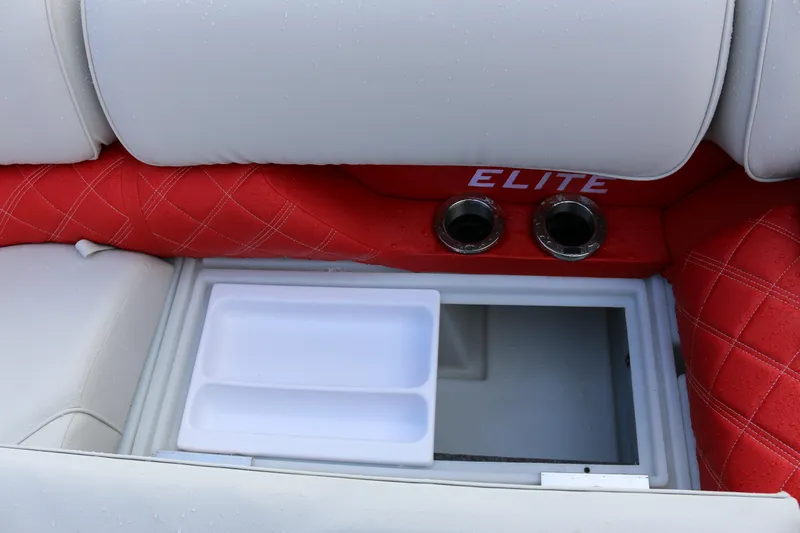 Slide: The Image of Interior of 2025 SunCatcher Elite 324 RC boat with red and white seating and storage compartment. - 29