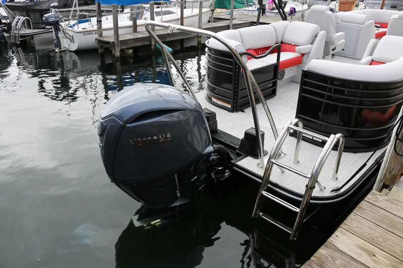 Slide: The Image of 2025 SunCatcher Elite 324 RC pontoon boat docked with Yamaha outboard motor. - 31