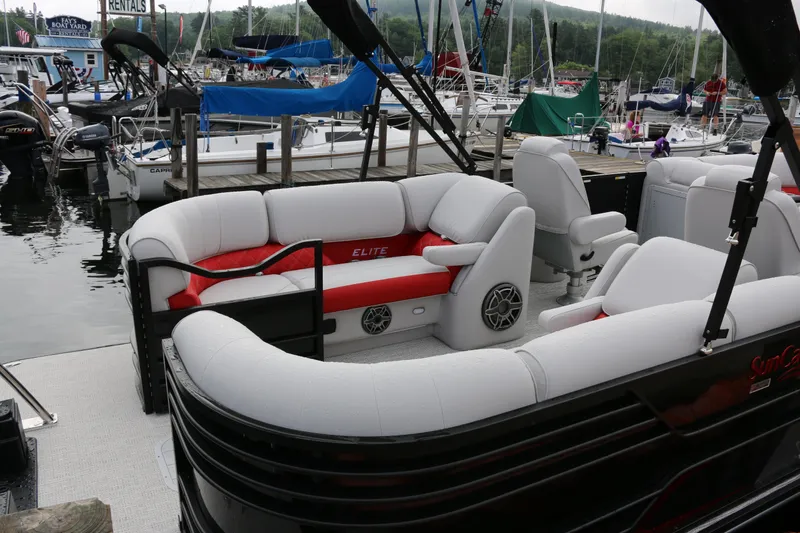 Slide: The Image of 2025 SunCatcher Elite 324 RC pontoon boat with luxurious seating at a marina. - 35