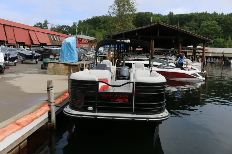 Slide: The Image of 2025 SunCatcher Elite 324 RC pontoon boat docked at a marina. - 38