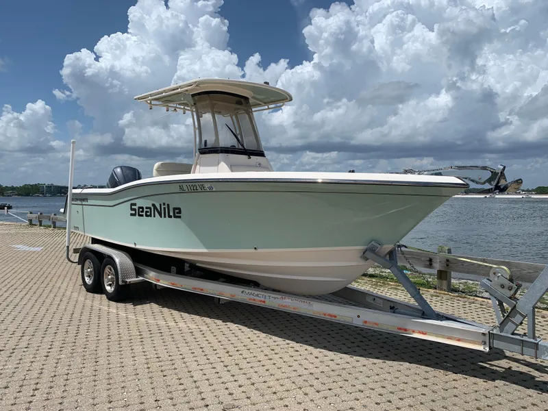 The Image of 2020 Grady-White 236 Fisherman boat on trailer by waterfront under cloudy sky. - 0