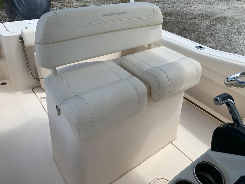 Slide: The Image of 2020 Grady-White 236 Fisherman boat seating with white upholstery and control panel. - 20