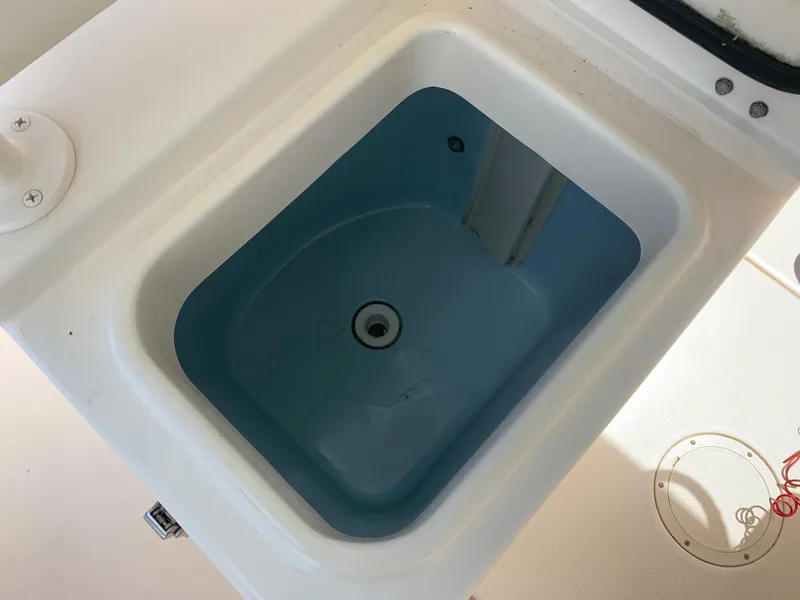 Slide: The Image of Livewell on 2020 Grady-White 236 Fisherman boat, featuring a blue interior. - 22