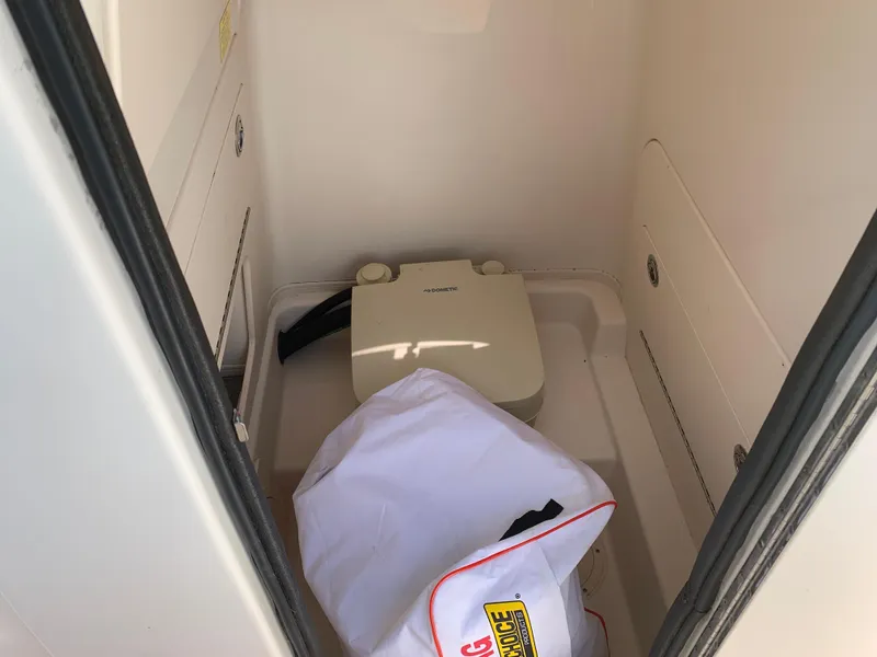 Slide: The Image of 2020 Grady-White 236 Fisherman boat interior with portable toilet and storage area. - 27