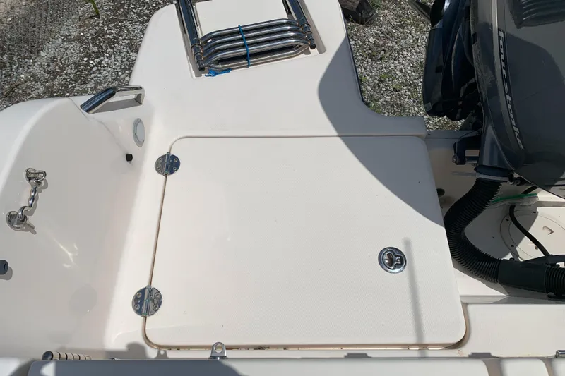 Slide: The Image of 2020 Grady-White 236 Fisherman boat deck with storage hatch and engine detail. - 46