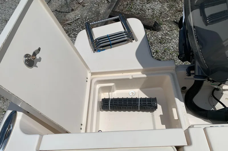 Slide: The Image of 2020 Grady-White 236 Fisherman boat storage compartment with ladder and engine detail. - 47
