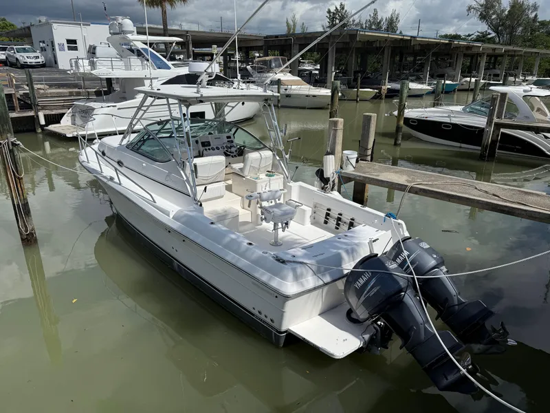Slide: The Image of 2004 Stamas 320 Express boat docked with dual Yamaha outboard engines. - 1