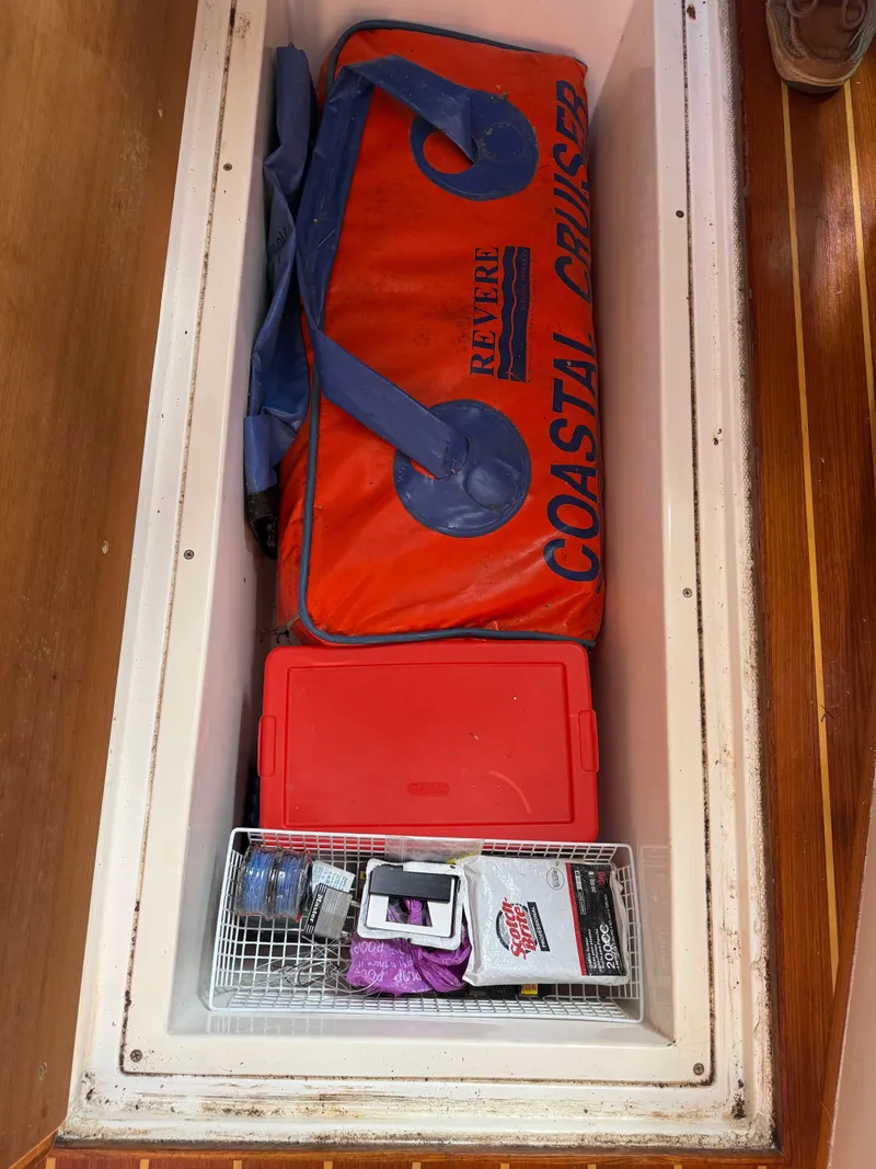 Slide: The Image of Storage compartment on a 2004 Stamas 320 Express with safety gear and supplies. - 12