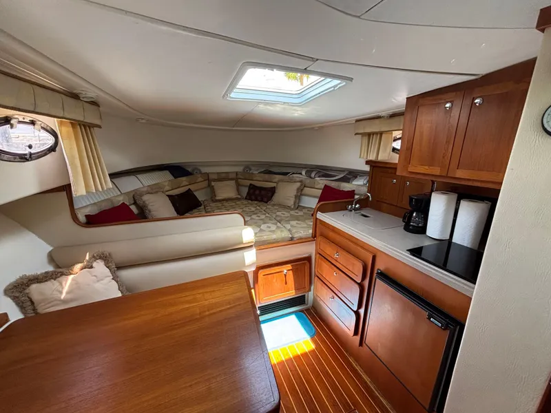Slide: The Image of Interior of 2004 Stamas 320 Express boat with cozy seating and kitchenette. - 2