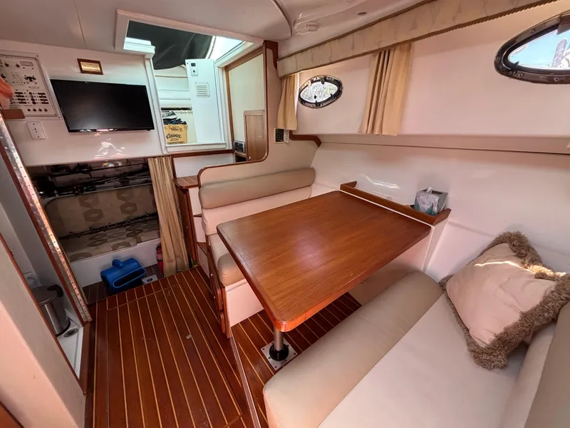 Slide: The Image of 2004 Stamas 320 Express cabin interior with dining area and TV. - 3