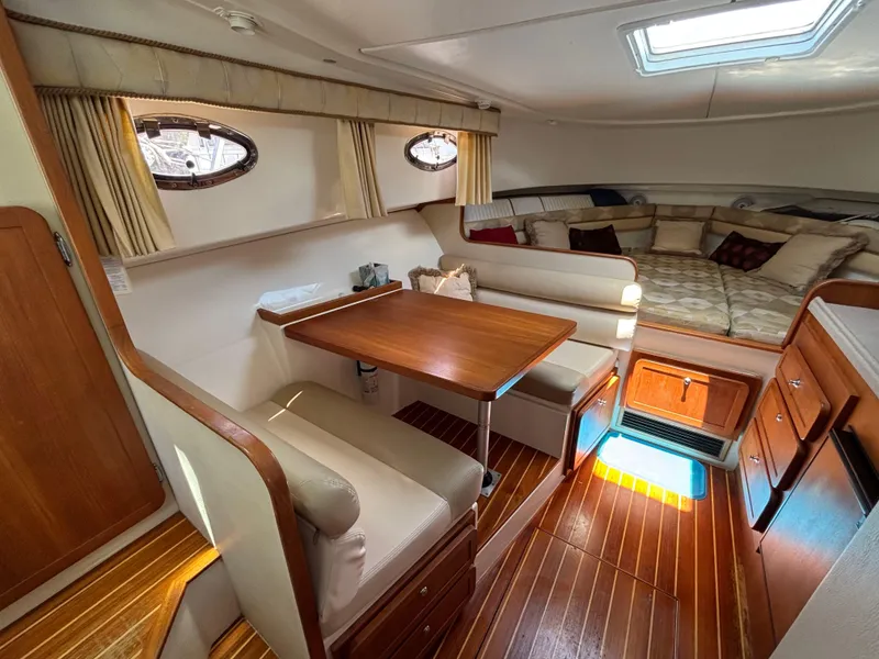 Slide: The Image of 2004 Stamas 320 Express cabin interior with dining area and cozy seating. - 7