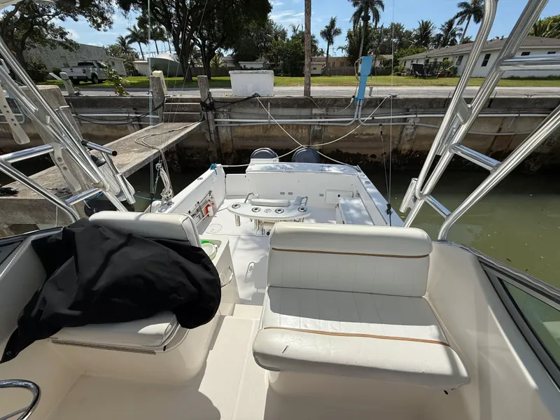 Slide: The Image of 2004 Stamas 320 Express boat interior with seating, docked by a canal. - 9