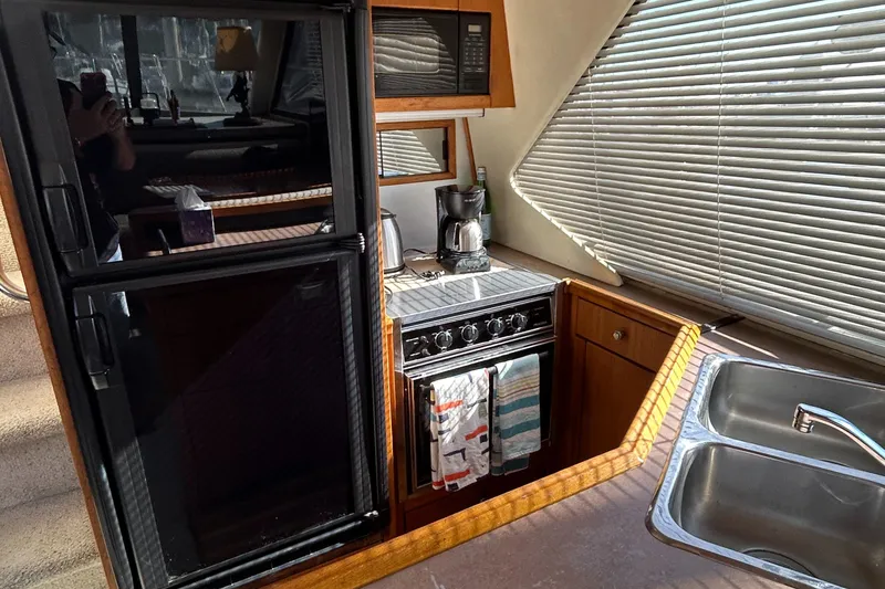 Slide: The Image of 1996 Bayliner 4087 Aft Cabin Motoryacht kitchen with stove, fridge, and sink. - 12