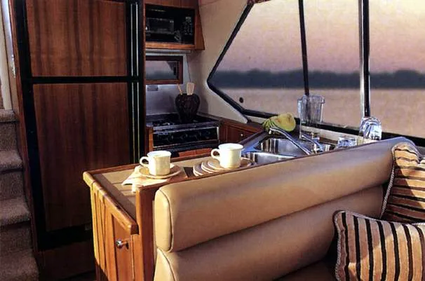 Slide: The Image of Interior of 1996 Bayliner 4087 Aft Cabin Motoryacht with kitchen and seating area. - 13