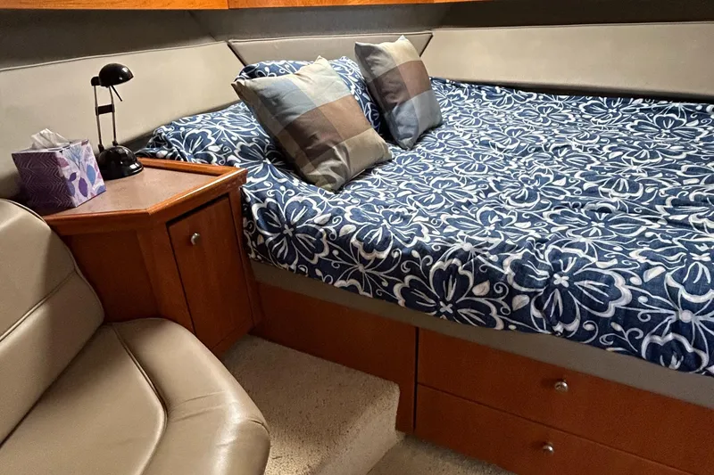 Slide: The Image of 1996 Bayliner 4087 Aft Cabin Motoryacht interior with bed, pillows, and wooden cabinetry. - 14